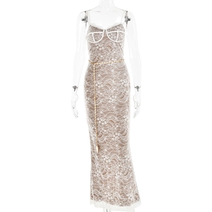 Beige lace maxi dress with thin straps, white trim, and a decorative gold chain belt