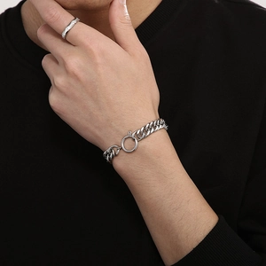 Detail of silver curb chain bracelet with large spring clasp and matching signet ring