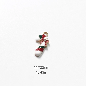 Macro detail of Christmas candy cane pendant with red bow and rhinestone, 11x22mm size