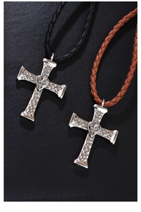 Detail of silver cross bolo ties with textured heart center and braided leather cords