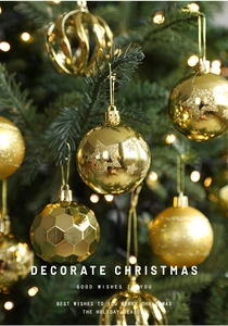 Close-up of golden Christmas balls with glitter and star patterns on a lighted tree