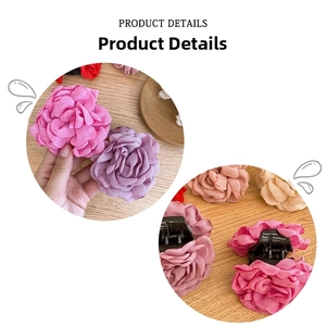 Detail of multi-colored fabric rose hair claw clips showing texture and grip design