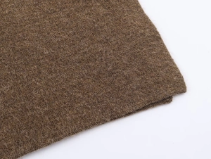 Macro shot of high-quality coffee brown knitted cashmere fabric texture for women cape