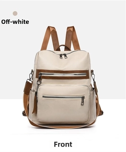 Front view of beige leather backpack with brown zipper trim and textured finish
