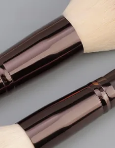 Close-up of thick bronze aluminum ferrule and soft synthetic makeup brush bristles