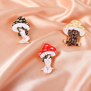 Set of 3 creative mushroom girl enamel pins in red, yellow and black on pink silk fabric