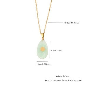 Detailed view of irregular natural stone pendant with gold sun motif on 17.7-inch chain
