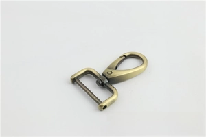 Detail of vintage bronze metal swivel lobster clasp for leather bags and straps