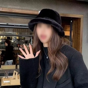 Fashionable black faux fur bucket hat for winter travel and warm outdoor style
