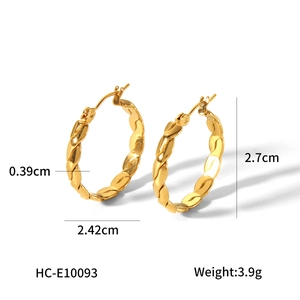 Macro shot of gold twist earrings showing dimensions 2.42cm x 2.7cm and texture