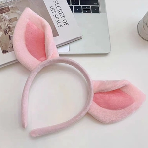 Close-up of soft pink plush pig ears headband with fuzzy texture for photo props