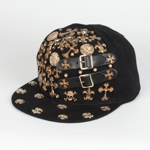 Detail of hip hop cap with gold cross, skull studs and leather buckle straps