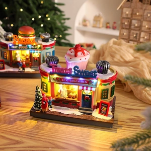 Close-up of lighted miniature resin hamburger and ice cream shops for Christmas