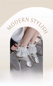 Detail of white ruffle lace ankle socks with double-layered frills paired with silver shoes