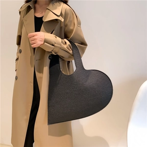Chic black heart-shaped felt tote bag featuring a unique asymmetrical designer silhouette