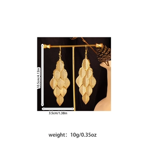 Detail showing dimensions and weight of long golden leaf tassel earrings on display