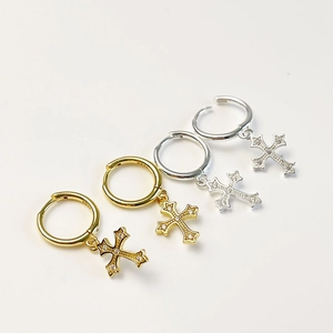 Macro shot of S925 sterling silver cross hoop earrings with cubic zirconia stones