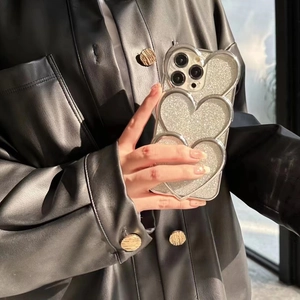 Detailed close-up of a silver glitter phone case with 3D stacked hearts for iPhone