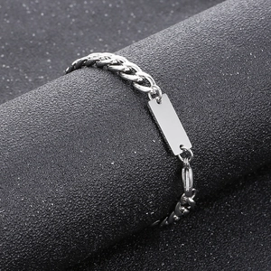 Detailed view of silver 7mm stainless steel Cuban chain link with a polished metal nameplate