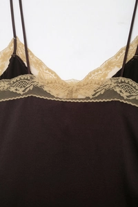 Close-up of brown satin camisole top featuring delicate champagne lace trim details