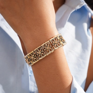 Close-up of a vintage gold floral bracelet with sparkling champagne zircons on wrist