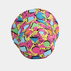 Reversible bucket hat with vibrant 90s Memphis geometric patterns in pink and yellow