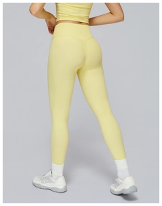 Close-up of seamless light yellow high-waisted yoga leggings and sports bra set