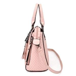 Detail view of pink woven texture handbag with metallic zippers and side pocket