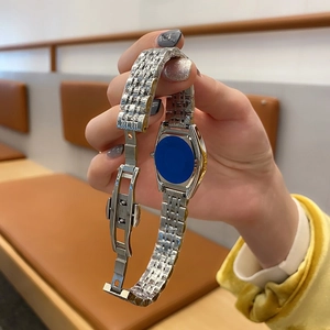 Detail view of silver stainless steel watch band featuring a secure butterfly clasp