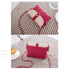 Detail view of mini crossbody bag in pink and beige featuring a gold reindeer charm