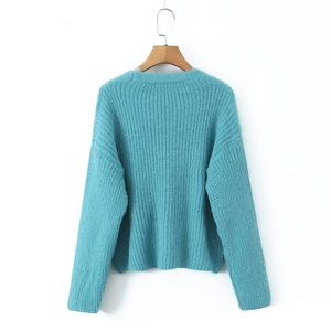 Close-up of soft cyan mohair knit cardigan showing detailed fluffy texture and stitching