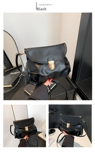 Detail of black pleated PU leather crossbody bag featuring a golden metal buckle closure