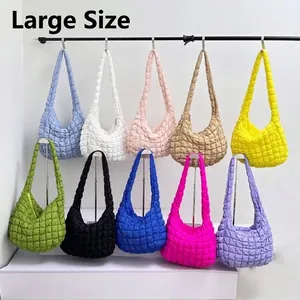 Large quilted puff dumpling shoulder bags in multiple vibrant colors shown on display