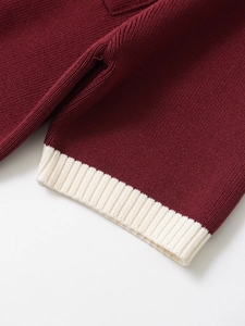 Detailed macro view of the burgundy knit fabric and ribbed white cuff finishing