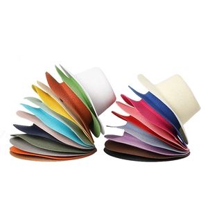 Detailed top view of stacked boater straw hats in multiple vibrant summer colors