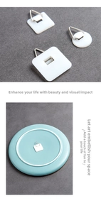 Close-up of self-adhesive plastic wall hangers for decorative plates with metal hooks