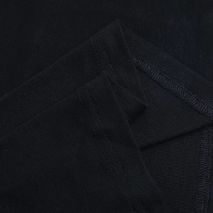 Close-up of black knitted fabric texture with double-needle stitching and reinforced seams