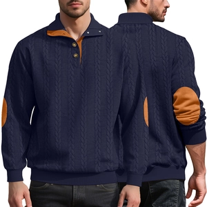 Detail of navy knit sweater showing cable knit texture and contrasting orange collar lining