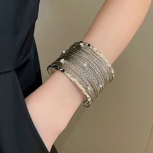 Detail of multi-layer crisscross open cuff bracelet with sparkling rhinestones for women