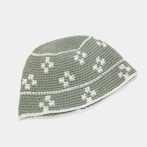 Handmade crochet bucket hat in sage green with white floral patterns for sun protection