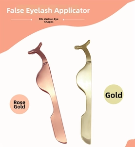 Detail view of rose gold and gold metal false eyelash applicators with curved tips