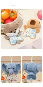 Detail of plush animal pendants with floral outfits, featuring elephant and capybara designs