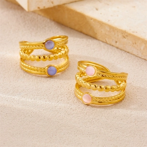 Macro view of multi-layer 18k gold plated gemstone rings with twisted rope and bead patterns