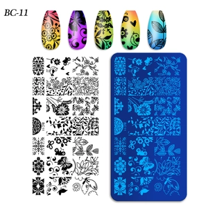 Macro view of rectangular nail art stamping plate with flower and butterfly patterns