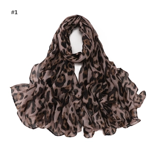 Detailed view of lightweight leopard print scarf with soft brown and black patterns