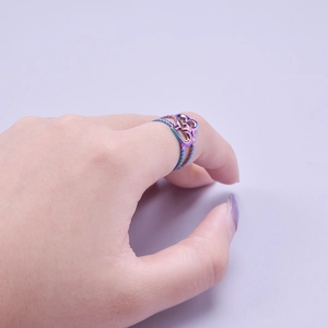 Detail of adjustable rainbow titanium steel ring with heart motif on model hand
