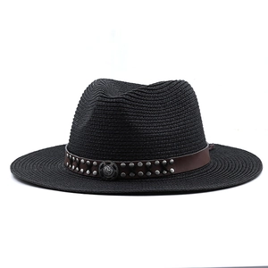 Close-up of black woven straw cowboy hat with brown faux leather studded band