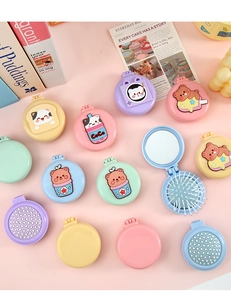 Close-up of cute cartoon folding air cushion hairbrushes with mirrors in pastel colors