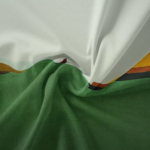 Close-up of bohemian wall tapestry fabric showing green and white woven texture with folds