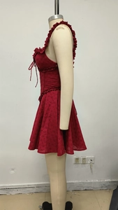 Detail of red eyelet embroidery fabric and ruffled lace on a mini party dress